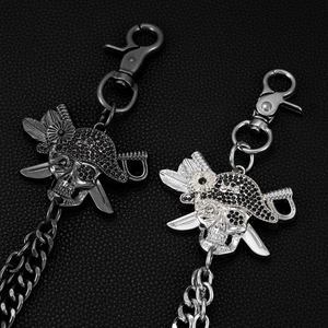 Detail of hip hop punk trousers chains featuring pirate skull pendants with rhinestones