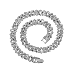 Macro shot of 14mm silver Cuban link chain with full diamond pavé and secure jewelry clasp