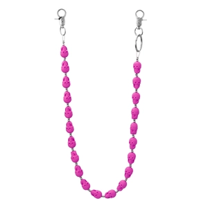 Detailed macro view of vibrant pink skull beads on a silver metal hip-hop keychain