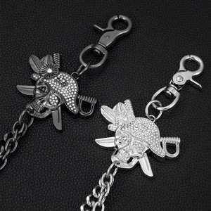 Macro shot of punk style silver and black skull waist chains with rhinestone hats