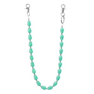 Close-up of matte green skull beads and silver metal spacers on a hip-hop chain accessory