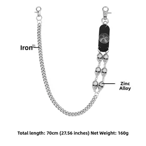 Detail of silver metal punk wallet chain with skull charms and leather cross patch