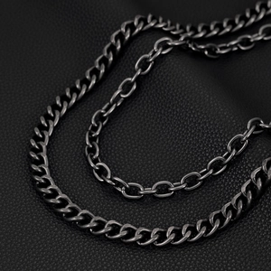 Detail of dual-layer gunmetal hip hop chains on black leather, punk style pants chain macro