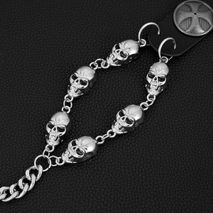 Punk style metal waist chain featuring 3D skull charms and a cross leather buckle