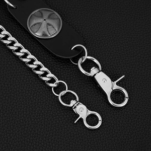 Detail of punk silver metal wallet chain with leather tab and cross motif studs