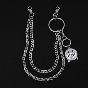Detail of a 3-layer punk pants chain with a rhinestone monster pendant and lobster clasps