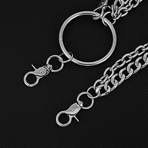 Detail of silver metal pants chain with large ring and lobster clasps on black leather