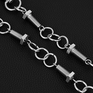 Macro shot of industrial style stainless steel chain with bolt and nut details on leather
