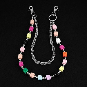 Detail of colorful building block beads on a silver pants chain with metal lobster clasp