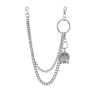 Macro detail of silver double-layered pants chain with iced-out blue eye ghost pendant