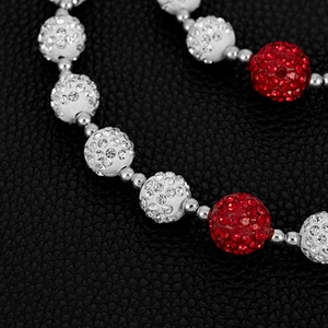 Detailed close-up of 14mm red and white pavé crystal disco balls on a hip-hop chain