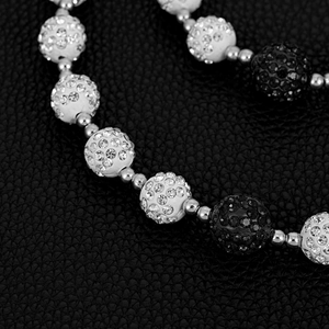 Macro shot of 14mm Shamballa crystal disco balls on a black and white hip hop waist chain