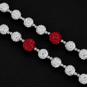 Macro detail of 14mm Shamballa disco balls with red and white pave crystals on a hip-hop chain