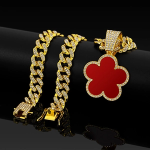 Gold Cuban chain necklace with red mother-of-pearl style clover pendant and rhinestones