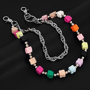 Close-up of colorful cheese cube charms and silver metal link hip-hop waist chain