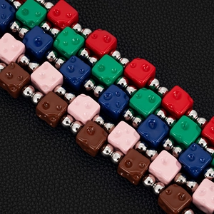 Detailed macro view of colorful dice cubes and metallic beads on a hip hop hip chain
