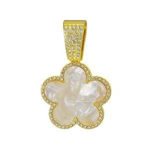 Macro detail of gold-plated five-petal clover pendant with mother of pearl and zircons