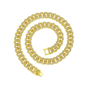 Macro shot of gold-plated 13mm iced out Cuban link chain with detailed crystal clasp
