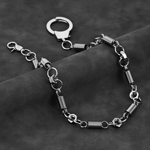 Close-up of industrial punk style wallet chain with hex nuts and handcuffs clasp