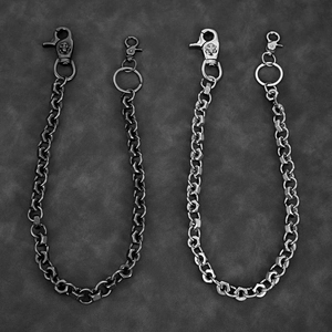 Close-up of industrial hexagon link pants chains with skull lobster clasps in silver and black