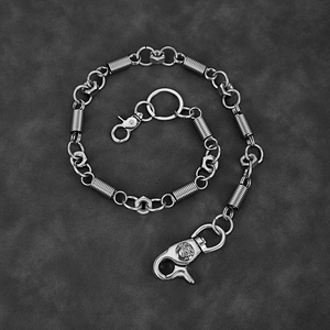 Industrial silver metal waist chain featuring spring coils, nuts and skull carved hooks