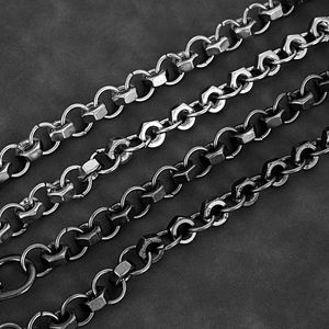 Close-up of industrial punk chain with metallic rings and hexagonal nut links on leather