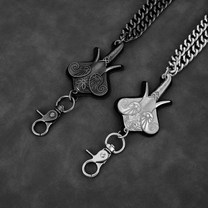 Detail of vintage elephant head charms with floral patterns and flat chunky metal chains