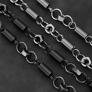 Macro detail of industrial style metal pant chains with spring and nut charms