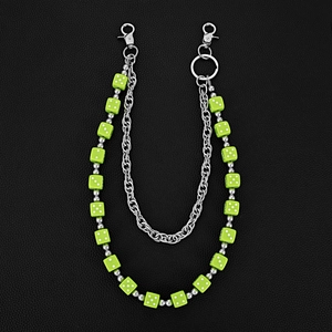 Detail of double-layer metal waist chain with vibrant green dice beads on black leather