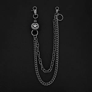 Detail shot of vintage punk double chain belt with embossed star charm on leather