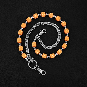 Fashionable layered waist chain with orange acrylic dice and silver metal beads on leather