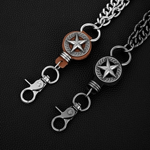 Macro shot of punk style double star pant chains with lobster clasps and leather details