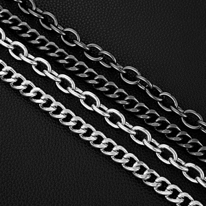 Detailed macro view of heavy-duty curb and oval metal chains on black leather texture