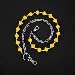 Handmade layered yellow cat paw chain with silver metal beads on black leather backdrop