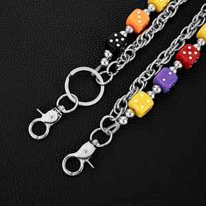 Detail of metal pant chain with colorful acrylic dice charms and silver lobster clasps