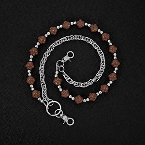 Detailed view of silver layered chain with cute brown bear paw charms on black leather
