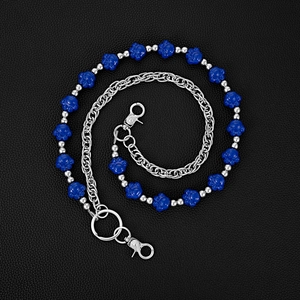 Detailed macro of silver multilayer waist chain with blue bear paw beads on leather