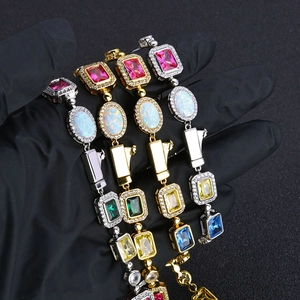 Detailed close-up of luxury gold and silver bracelets with colorful zircon and opal stones