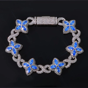 Luxurious Cuban link bracelet with blue zircon four-leaf clovers and pavé diamond setting
