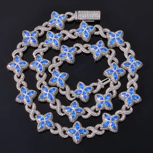 Detailed view of hip hop clover necklace with blue marquise stones and white diamonds