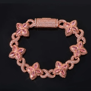 Macro detail of rose gold clover bracelet with pink marquise stones and zircon pavé