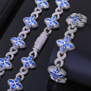 Detail of silver Cuban chain with infinity links and blue marquise flower zircon inlay