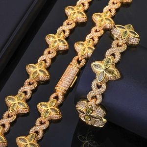 Detailed macro view of gold-plated clover jewelry set with sparkling zircon inlays