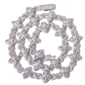 Detailed macro view of silver clover link chain necklace with sparkling cubic zirconia
