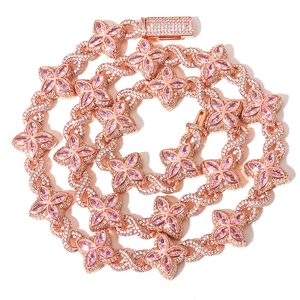Macro shot of rose gold Cuban link chain with pink flower motifs and zircon stones