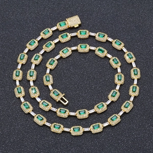 Detailed close-up of emerald green zircon stones and micro-pave crystals on a gold necklace