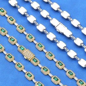 Detailed macro of hip-hop jewelry chains with emerald gemstone and micro-pave zircon settings