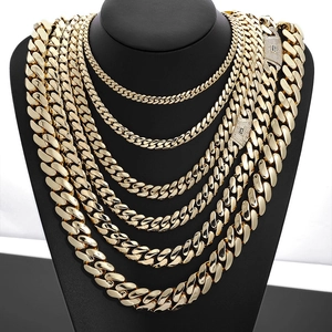 Detail of seven tiered 14K gold cuban link chains with diamond paved S logo buckles