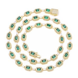 Detailed close-up of emerald-cut green gemstones and zircon micro-pave hip hop necklace
