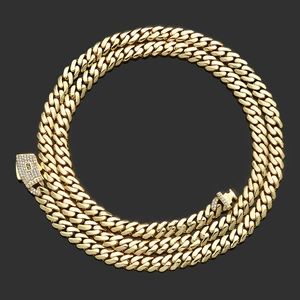 Close-up of a 14K gold plated Cuban link chain with a sparkling diamond-set S clasp